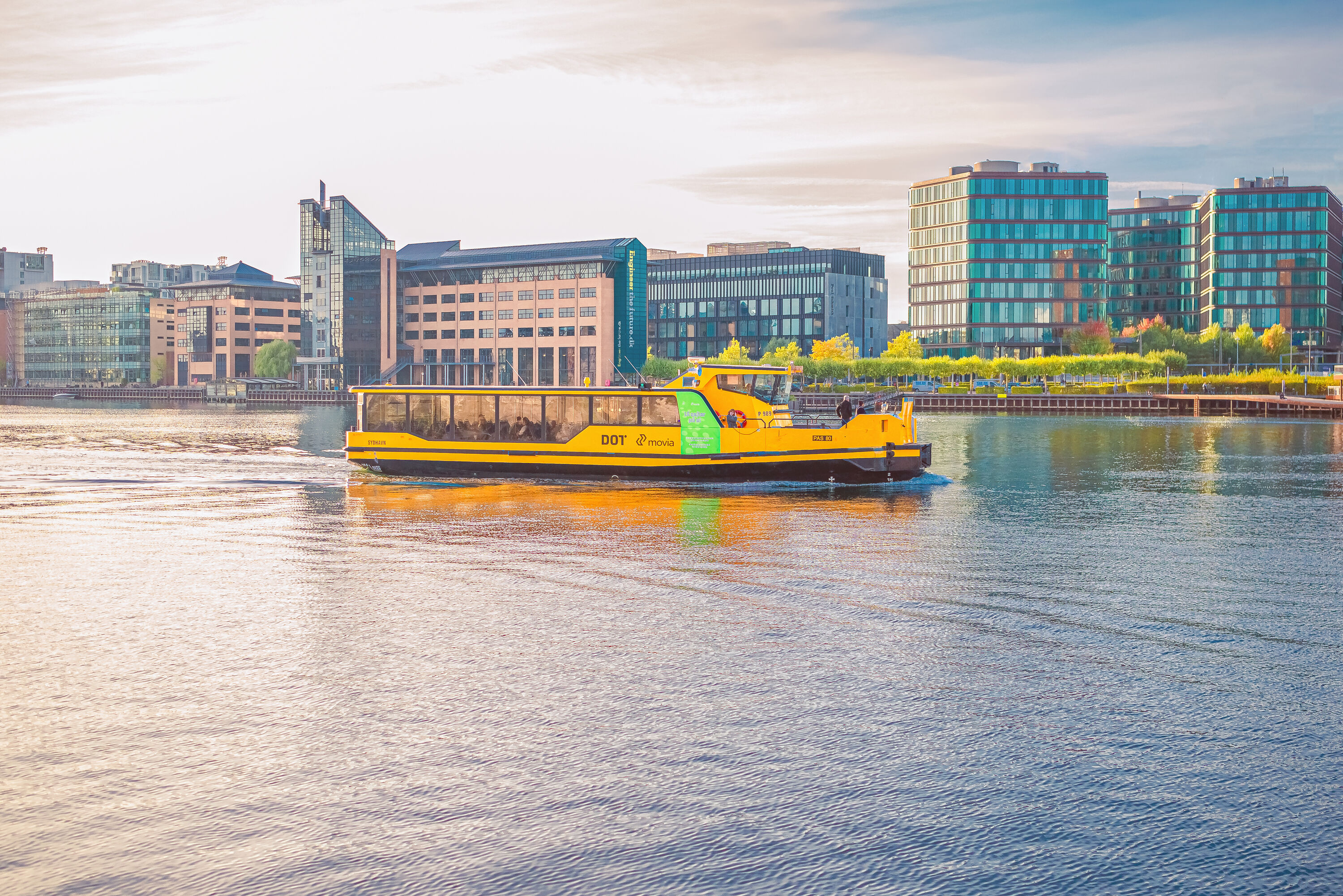 Yellow Copenhagen Harbour water Busesthe sails along the city canal harbourfront near residential buildings of Copenhagen, Denmark