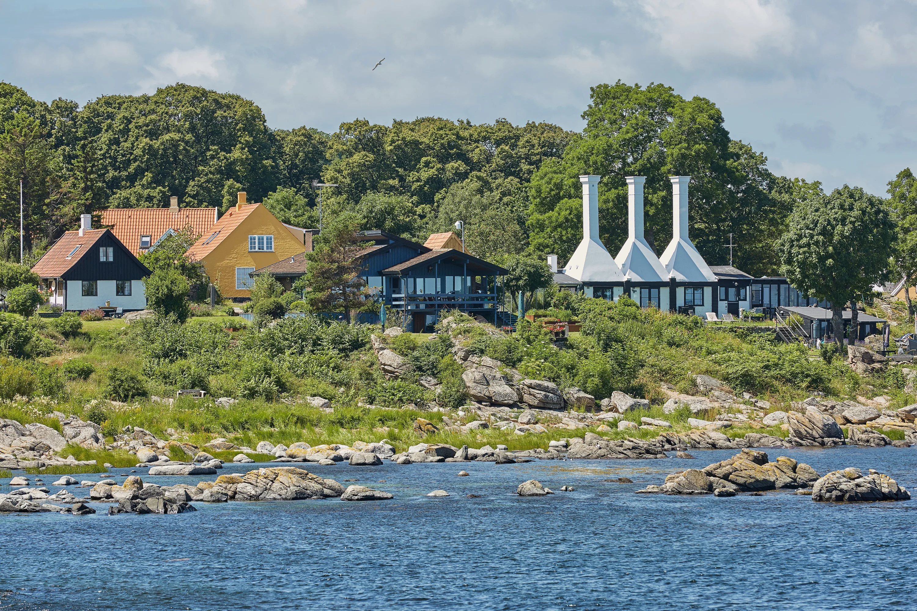 The roofs and chimneys of very small smoke houses so typical and famous for small village of Svaneke on Bornholm island in Denmark